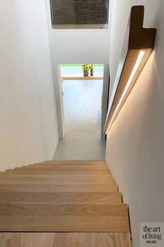 there is a light that is on the wall above the stairs in this house,