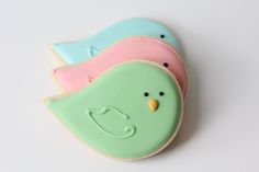 three decorated cookies in the shape of birds