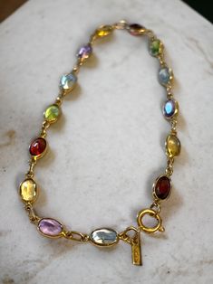 LOVELY Vintage 14K Yellow Gold Multi-Color Gemstone 7" Bracelet! * In beautiful pre-owned condition. * Beautiful gemstone bracelet with fourteen (14) assorted oval gems including garnet, amethyst, citrine, and peridot! * Hallmarked/Tested 14k * Weighs 2.8 Grams * Measures approximately 7" long from end to end. * Secure spring ring closure Please message me with any questions Shipped FAST and FREE, fully insured and in a gift box :) I guarantee item to be exactly as described and pictured. Dream Accessories, Gems Bracelet, Natural Gemstone Jewelry, Gemstone Bracelet, Chain Link Bracelet, Gemstone Jewelry, Vintage Jewelry