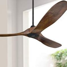 a wooden ceiling fan hanging from the ceiling