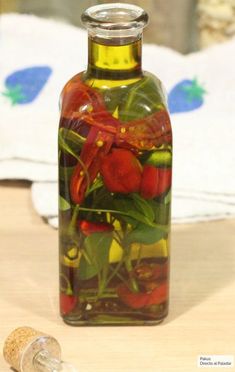 a glass bottle filled with red and yellow flowers