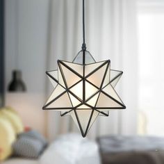 a star shaped light hanging from the ceiling