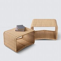 a wicker coffee table and end table with a book on top, sitting next to each other