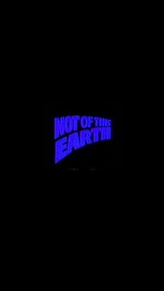 a neon sign that says not of the earth in blue on a dark black background