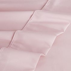 the pink sheets and pillow cases are folded together