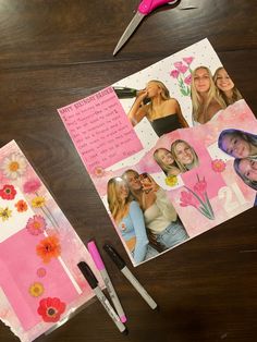 a table topped with pictures and scissors next to pink paper on top of a wooden table