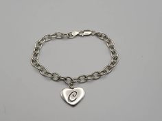 Vintage 925 Silver Monogram Initial C Heart Bracelet  Item w#1620 Clean and in good condition  7.5 inches long  Lobster claw clasp Marked 925 9.8 grams Welcome to Westgate Jewels! At Westgate Jewels, we specialize in vintage estate jewelry, vintage designer jewelry, Vintage Native American jewelry and wears, Collectables, and Vintage fine karat gold and sterling silver jewelry. Our Collection Our shop features items in estate, antique, and vintage condition (unless otherwise noted). These pieces Vintage Jewelry Initial C, Letter C Heart, C Bracelet, C Heart, Initial C, Vintage Native American Jewelry, Vintage Designer Jewelry, Silver Monogram, Letter C