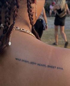 a woman with a tattoo on her back saying wild spirit got heart, sweet soul