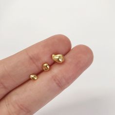 These cute tiny stud earrings are entirely made of sterling silver and plated with 18K gold.  They are completely nickel-free and therefore also suitable for allergy sufferers. Dainty and playful addition to your everyday earrings collection.  Take a look in my shop to discover more designs that are perfect for you: https://www.etsy.com/shop/olioliBoutique ------------------------------------------ Measurements and Details:   » Material:  Handmade with genuine 925 Sterling Silver and love : )   » Approximate Size:  as shown in the photos    Tips to make your jewelry last longer:   » Keep dry! Do not bathe/shower or spray perfume on them.   » Apply makeup and hairspray BEFORE you put on your jewelry.     [Always last on, first off] Please let me know if you have any questions or requests, I Gold Dainty Tarnish-resistant Cartilage Earrings, Dainty Gold Cartilage Earrings Tarnish Resistant, Tiny Gold Huggie Cartilage Earrings, Nickel Free Gold Piercings For Everyday, 14k Gold Tarnish-resistant Piercings As A Gift, Gold Nickel-free Piercings For Everyday, Nickel-free Gold Huggie Piercings, Minimalist Gold Plug Earrings As Gift, Nickel Free Gold Huggie Piercings