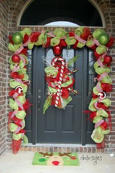 the front door is decorated for christmas with candy canes