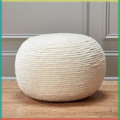 a large white ball sitting on top of a wooden floor