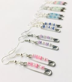 a row of different colored glass bead earrings