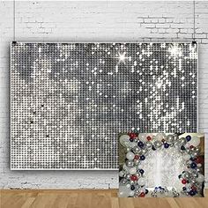 a white brick wall with silver sequins on it and a large mirror in the middle