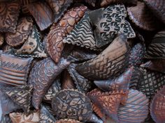 a pile of carved wooden objects sitting next to each other