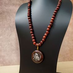 37" This Uniquely Designed Double Sided Photo Pendant Necklace Expertly Combines Wild Country Rosewood and Meditation Beads for an Elegant and Timeless Look. Handcrafted with Quality Materials, The ORIGINAL OSHO Rajneeshpuram Wild Country Rosewood Meditation Beads Mala Necklace Is the Perfect Accessory for Your Mindful Journey. ✥ Pendant size ✥ Necklace length - 37" (w/o pendant 35") ✥ Handmade by Artisans in India ❀❀❀Please look closely at photos as part of item description, the product in the Traditional Brown Necklace For Gift, Brown Natural Stones Mala As A Gift, Traditional Brown Beaded Necklaces For Gifts, Traditional Brown Mala As Gift, Traditional Brown Beaded Necklace For Gift, Traditional Mahogany Jewelry As Gift, Brown Long Necklace With 108 Beads, Long Brown Necklace With 108 Beads, Traditional Natural Necklace For Meditation