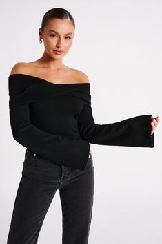 A bare essential.MARLISSA is a long-sleeved, off-shoulder top with a twisted fabric neckline and bodycon fit. It also features a low, open back with adjustable sliders for a better, more custom fit. The fabric panel along the neckline twists at the back and centre, adding to the visual texture. The torso is fitted while the sleeves are long and flared, creating a balanced silhouette. Pair with fitted jeans like our Tina Mom Jeans for an easy day look. FEATURES: Off shoulder neckline Front overla