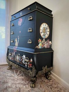 an ornate black chest with pictures on it