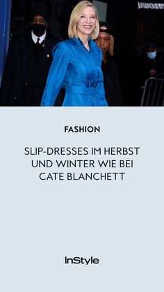 a woman in a blue dress is walking out of a building with the caption fashion slip - dresses im herbst und winter we be cate blanchett