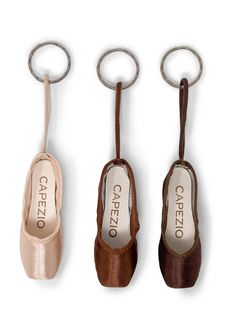 Accessorize your favorite dance bag with the Pointe Shoe Keychain! Perfect for giving as a gift to your favorite dancer or for treating yourself. Metal key ring for easy attaching to any zipper. Available in three different colors with dyed-to-match binding. Capezio logo on sock lining and outsole. One Size. Product Features: 100% Satin One Size: 2 3/4"l x 1"w x 1"h (6.7cm x 2.5cm x 2.5cm), not including keyring and string Metal key ring attached Capezio logo on sock lining Capezio logo on the o Childrens Leotards, Shoe Keychain, Flamenco Shoes, Hair Accessories Bun, Pointe Shoe, Dance Sneakers, Jazz Shoes, Dance Gifts, Engraved Keychain