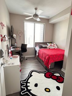 a bedroom with a hello kitty rug on the floor