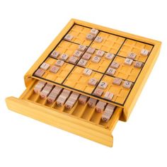 a wooden board game set with numbers and dices on the top, in a yellow case