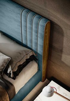 a bed with a blue headboard and pillows