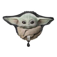 the child yoda mask is hanging on a wall