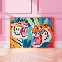 two tiger paintings in front of a pink wall