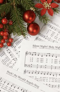 sheet music with christmas decorations on top