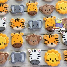 many decorated cookies are arranged in the shape of animals