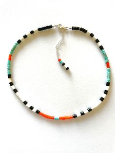 Colorful multi gemstone beaded choker necklace featuring natural 4mm blue turquoise and black onyx heishi beads, vintage orange white heart trade beads from Venice circa 1800's, and natural off white ox bone tube beads. Beaded choker necklace is 15 1/2 inches plus 2 inch extension. All metals are .925 sterling silver. Perfect splash of summery color! Black Heishi Beads Jewelry, Handmade Black Heishi Beads, Black Heishi Beads Necklace For Gift, Black Heishi Beaded Necklaces, Black Beaded Heishi Beads Necklace, Adjustable Heishi Bead Jewelry With Black Beads, Adjustable Black Choker With Colorful Beads, Silversmithing Jewelry, Turquoise Choker