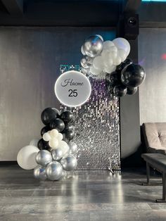 balloons and streamers are on the floor in front of a sign that says home