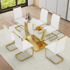 a glass dining table with white chairs and a gold metal base is shown in front of a large window