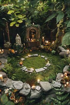 a circular garden with candles in the middle and lots of greenery around it, surrounded by rocks