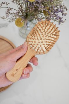 Brush your hair sustainably with our bamboo hairbrush! Made from sustainably sourced bamboo with a natural rubber cushion and bamboo pins. This little brush is gentle on tangles, helps reduce static and frizz, and comes in a convenient size that is perfect for travel, on-the-go, or kids! Care Instructions: Brush is water resistant, use on wet or dry hair. Avoid excessive water exposure to increase longevity. If the brush becomes wet, use a towel to dry and allow to air out before putting away. O Bamboo Hairbrush, Burgundy Bouquet, Travel Hair, Bamboo Brush, Travel Hairstyles, Laundry Decor, Wet Brush, Holiday Feast, Styling Brush