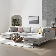 a living room with a sectional couch and coffee table