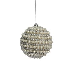 a christmas ornament with pearls hanging from it's side on a white background