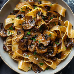 pasta with mushrooms and parsley in a white bowl