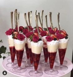 there are many desserts with strawberries in them on the cake platter,