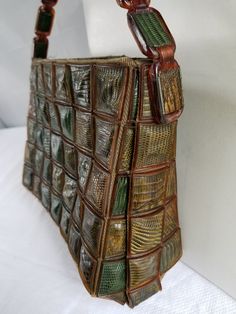 "This 1940's-50's PATCHWORK REPTILE SKIN BAG is VERY RARE. In various shades of browns & greens this purse could be created from snake, lizard OR alligator skins. Maybe a combination of all three (3). You decide. Each square of reptile skin is set in a brown plastic frame. ( see photos for details ) This unusual bag has a 16 \" strap & measures approximately 9\" wide X 6 1/2 \" tall. The liner & metal zipper is \" Army Green \" with no signs of wear. This purse is in VERY GOOD-EXCELL Vintage Green Rectangular Shoulder Bag, Vintage Green Square Bag, Vintage Square Green Bag, Micro Mosaic Jewelry, Reptile Skin, Alligator Skin, Bangle Bracelet Set, Micro Mosaic, Metal Mesh