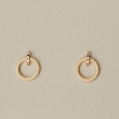 Minimalist earrings made from arched solid 14k gold studs and vintage bone rings. Bone rings can be worn in front or behind your earlobe, or taken out to wear the studs solo for a more subtle look. Vintage bone rings and 14k recycled yellow gold studs; earrings measure approximately 15mm in diameter. Complete with solid 14k gold backings. We love using sustainable alternatives like vintage bone. It is recycled, re-imagined and most importantly biodegradable unlike plastic counterparts commonly u Minimalist Everyday Beige Jewelry, Everyday Minimalist Beige Jewelry, Gold Studs Earrings, Bone Ring, Link Earrings, Minimalist Earrings, Gold Studs, Modern Jewelry, Biodegradable Products