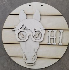 a wooden sign with a horse's head and the word hh on it