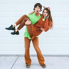 a man and woman dressed up as the characters from scooby holding each other