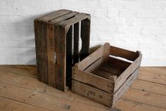 two wooden crates sitting on top of a wooden floor