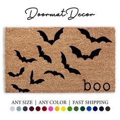 a door mat with bats on it and the words,'booo'written in black