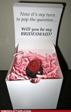 a white box filled with pink confetti next to a sign that says, now it's my turn to pop the question will you be my bridesmaid?