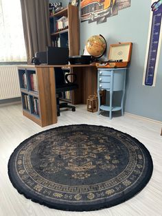 a room with a rug, desk and bookshelf