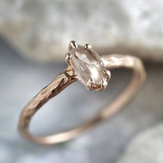 a gold ring with an oval cut diamond