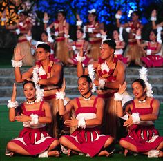 a group of cheerleaders pose for a photo in front of an audience on stage