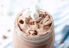 there is a chocolate drink with marshmallows in the top and on the side